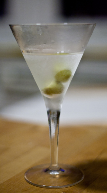 Frosty martini glass with two olives